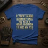Royal blue t-shirt with gold glitter text: "IF YOU'RE TALKING BEHIND MY BACK YOU ARE IN A GOOD POSITION TO