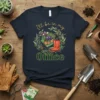 Gardening quote t-shirt with "I'll be in my Office" text, featuring a wheelbarrow, potted flowers, gardening tools, and red boots