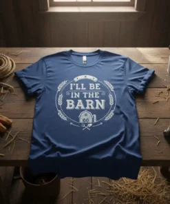 I'll Be In The Barn text with barn graphic and wheat wreath on a blue t-shirt