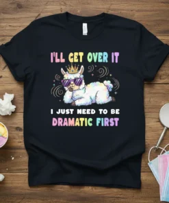 Black t-shirt with colorful text "I'll Get Over It I Just Need To Be Dramatic First" and a crowned, sunglass-wearing