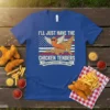 Blue t-shirt with "I'll Just Have The Chicken Tenders America's Favorite Finger Food" text and a winged chicken tender graphic