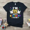 I'm 15 Happy Birthday To Me text and graphic on a navy t-shirt, featuring balloons and hands