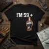 Black t-shirt with white text "I'm 59+" and a graphic of a hand giving the middle finger, outlined in orange