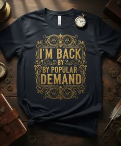 Black t-shirt with gold glitter "I'm Back By Popular Demand" text in ornate frame