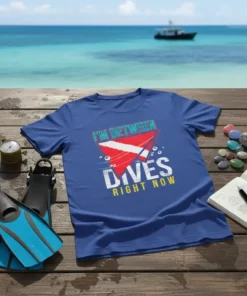 Blue t-shirt with "I'm Between Dives Right Now" text and red and white dive flag graphic, symbolizing scuba diving