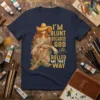 T-shirt with gold text "I'm Blunt Because God Rolled Me That Way" and a graphic of a woman with empowering