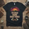 I'M BRAD DOING BRAD THINGS text with mountain and galaxy graphic, featuring crossed axes, on a black t-shirt