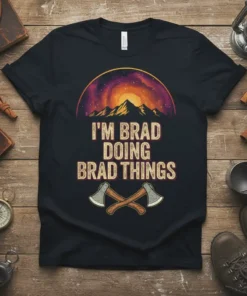 I'M BRAD DOING BRAD THINGS text with mountain and galaxy graphic, featuring crossed axes, on a black t-shirt