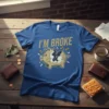I'm Broke t-shirt with a gold distressed font and a cracked piggy bank design spilling coins and dollar signs
