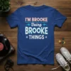 I'M BROOKE Doing BROOKE THINGS custom name t-shirt design with bold white and red lettering on a blue shirt