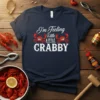 Navy t-shirt with white text "I'm Feeling Little A LITTLE CRABBY" and two cartoon crabs graphic