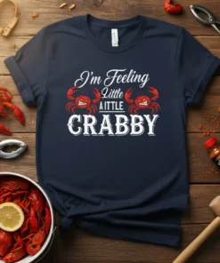 Navy t-shirt with white text "I'm Feeling Little A LITTLE CRABBY" and two cartoon crabs graphic