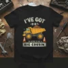 Dump truck graphic with "I've Got Dirt, I'm Going To Be A Big Cousin" text on a black t-shirt