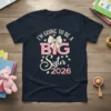 I'm Going To Be A Big Sister 2026 text with bow and hearts graphic on navy blue t-shirt