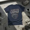 Navy t-shirt with "I'm Going To The Garage" text above a detailed graphic of a V8 engine
