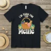 Black t-shirt with "I'm Here For The Picnic" text above a graphic of a picnic basket filled with food and