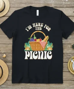 Black t-shirt with "I'm Here For The Picnic" text above a graphic of a picnic basket filled with food and