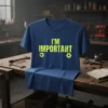 Blue t-shirt with neon yellow text "I'M IMPORTANT" and gear graphics, suitable for mechanics and engineers