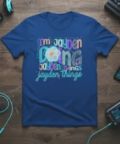 T-shirt with "I'm Jayden Doing Jayden Things Jayden Things" text in colorful, blocky font with a cute flower character
