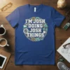 I'm Josh Doing Josh Things quote on a blue t-shirt with circular graphics of a rocket, laptop, gears, and game