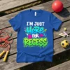 Blue t-shirt with "I'm Just Here For Recess" text in graffiti-style font, featuring colorful splatters and arrows