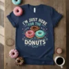 Navy t-shirt with the text "I'm Just Here For The Donuts" and colorful donut graphics