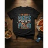 Black t-shirt with neon-style text reading "I'm Just Here For The Food" and crossed fork and spoon graphic