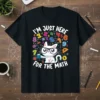 I'm Just Here For The Math T-Shirt featuring a white cat in glasses holding a calculator amidst colorful numbers and