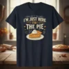 I'm Just Here For The Pie quote with a slice of pie graphic on a navy t-shirt