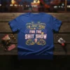 I'm Just Here For The Shit Show text design with fireworks and popcorn graphic on a blue t-shirt