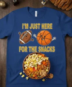 T-shirt with text "I'm Just Here For The Snacks" featuring cartoon football and basketball characters above a bowl of popcorn