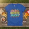 I'm Just Here For The Snacks quote on a blue t-shirt, surrounded by colorful illustrations of cookies, candy, and pretzels