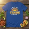 I'm Just Here For The Tacos quote with a retro sun graphic on a royal blue t-shirt
