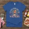 I'm Just Here For The Wieners t-shirt design featuring a cartoon hot dog on a podium with fireworks and stars