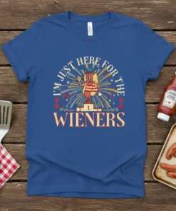 I'm Just Here For The Wieners t-shirt design featuring a cartoon hot dog on a podium with fireworks and stars