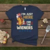 I'm Just Here For The Wieners t-shirt design featuring a cartoon hot dog in a patriotic hat and stars