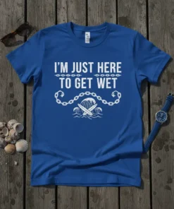 Blue t-shirt with white text "I'm Just Here To Get Wet" and a graphic of a surfboard in waves