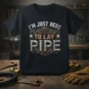 Black t-shirt with "I'M JUST HERE TO LAY PIPE" text in industrial-style lettering, featuring gears and gauges