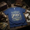 I'm Just Here To Pay For Everything quote in gold ornate typography on a navy blue t-shirt design
