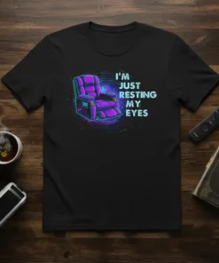 Black t-shirt featuring the text "I'm Just Resting My Eyes" above a glowing purple recliner chair graphic, with cosmic swirling