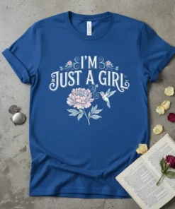 Blue t-shirt with "I'm Just A Girl" text, a pink peony flower, and a hummingbird graphic