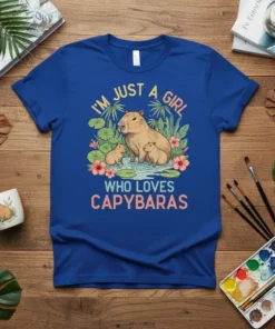 T-shirt with the text "I'm Just A Girl Who Loves Capybaras" featuring a mother capybara with two babies in a