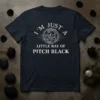 I'm Just A Little Ray Of Pitch Black quote with a circular snake graphic on a navy t-shirt