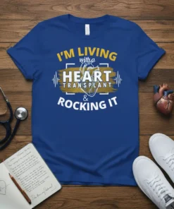 Blue t-shirt with white and gold text: "I'm Living With a Heart Transplant & Rocking It" and a heart graphic