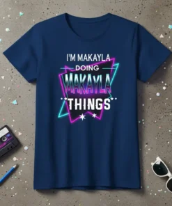 Retro graphic t-shirt with text "I'm Makayla Doing Makayla Things" in neon pink and blue outline on navy blue shirt