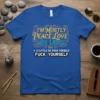Blue t-shirt with the quote "I'm Mostly Peace Love and Light + A Little Go Fuck Yourself Fuck Yourself" in