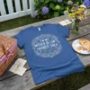 Blue t-shirt with "I'm My Mother-in-Law's Favorite Child" quote inside a floral wreath graphic