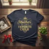 I'm My Mother In Law's Favorite Child quote in gold glittery font with a crown graphic on a navy t-shirt