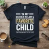 I'm My Mother In Law's Favorite Child quote on a navy t-shirt with white and gold text, funny family humor