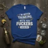 I'm Never Drinking With You Fuckers Again quote on a royal blue t-shirt with distressed white and gold lettering